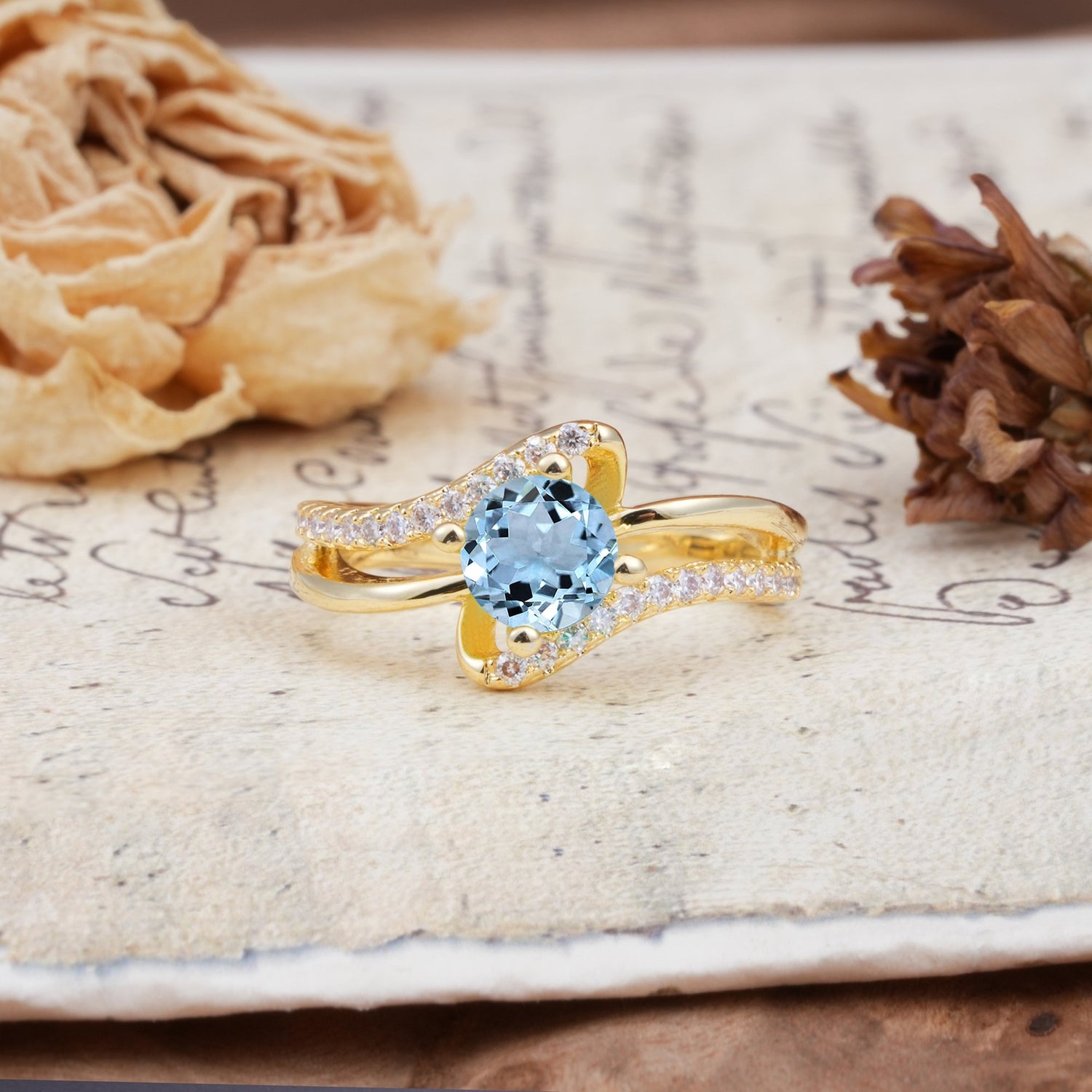 Uniquely Elegant, Twisting 4-Prong Round Cut Aquamarine Engagement Ring