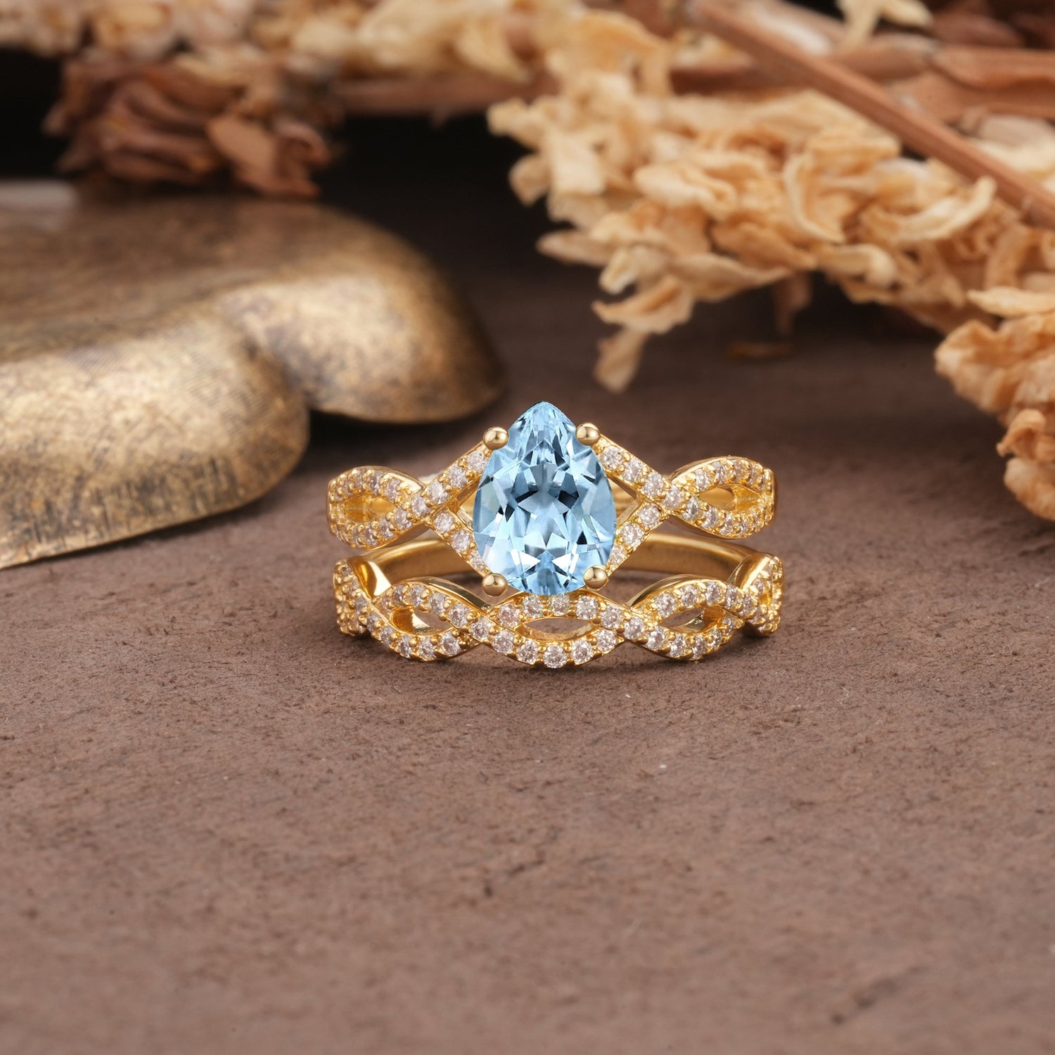 Luxurious and Unique: Entwined 4-Prong Pear Cut Aquamarine Bridal Ring Set